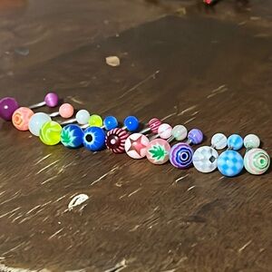 13 Multicolored Belly Piercings.